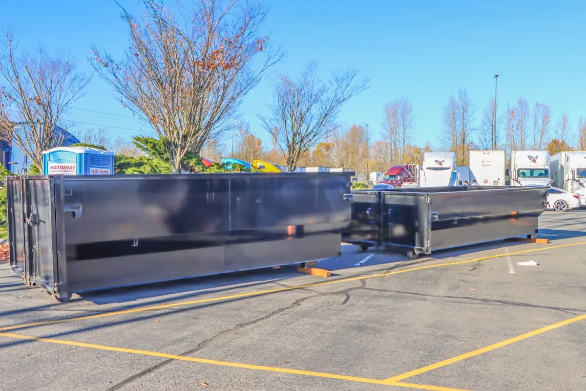 Professional dumpster rental service with roll-off container on residential driveway in Jerseyville